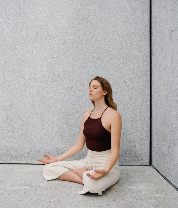 Person meditating at sunrise, embodying peace and mental clarity.
